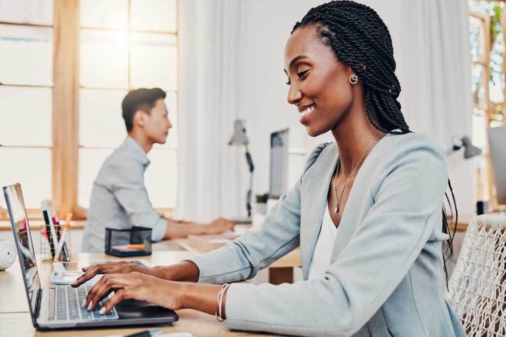 Finance-black-woman-office-and-laptop-typing-corporate-business-financial-accounting-online-profit-